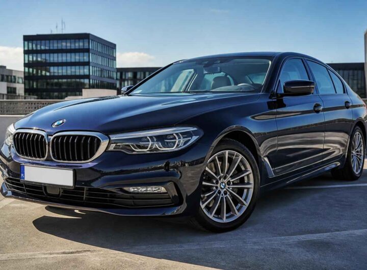 Granatowe BMW Serii 5 zaparkowane na dachu parkingu w słoneczny dzień