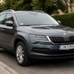 Szara Škoda Kodiaq zaparkowana przy krawężniku na miejskiej ulicy
